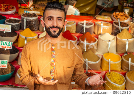 indian sallerman showing his small shop on arambol goa market 89612810