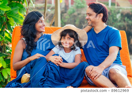 using eco metal recyclable tube.happy asian parents and cute girl enjoying summer vacation in Goa beach , drinking coconut water using eco metal recyclable tube.happy asian parents and cute girl enjoying summer vacation in Goa beach , drinking coconut water 89612969