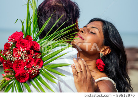 indian male making proposal with engagement ring and roses to his girlfriend at sea beach.Valentine day at Goa indian male making proposal with engagement ring and roses to his girlfriend at sea beach.Valentine day at Goa 89612970