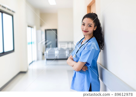 Female doctor stands at hospital. Healthcare worker. Female doctor stands at hospital. Healthcare worker. 89612978