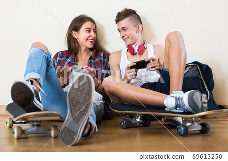 Teenagers sitting on floor with mobile phones . Teenagers sitting on floor with mobile phones . 89613250