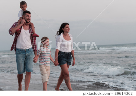 Happy young family have fun and live healthy lifestyle on beach. Selective focus  89614362