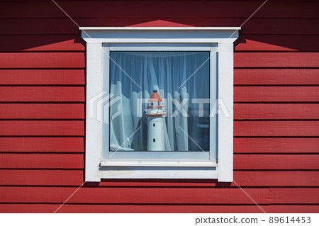 Wooden lighthouse model at the old scandinavian window Wooden lighthouse model at the old scandinavian window 89614453