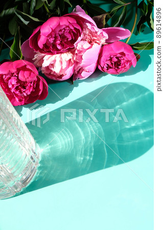 Pink peonies and leaves with hard shadow on pastel background. Trendy pattern, summer concept. Pink peonies and leaves with hard shadow on pastel background. Trendy pattern, summer concept. 89614896
