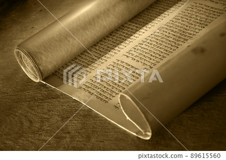 Ancient scroll lit by candlelight Ancient scroll lit by candlelight 89615560