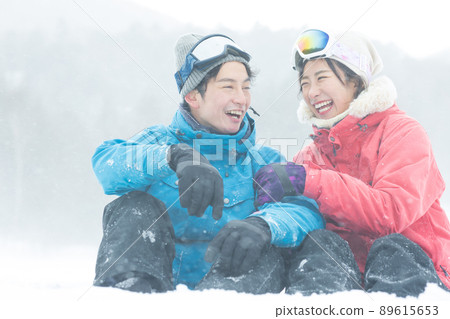 Couple enjoying the snowy mountains Couple enjoying the snowy mountains 89615653