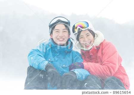 Couple enjoying the snowy mountains Couple enjoying the snowy mountains 89615654