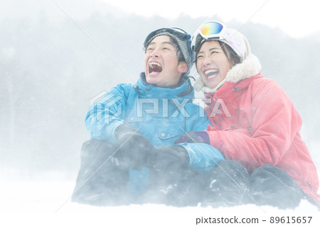Couple enjoying the snowy mountains Couple enjoying the snowy mountains 89615657