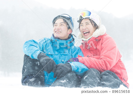 Couple enjoying the snowy mountains Couple enjoying the snowy mountains 89615658