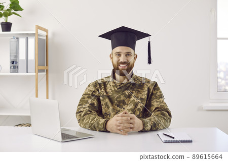 Smiling male military student in graduation cap 89615664