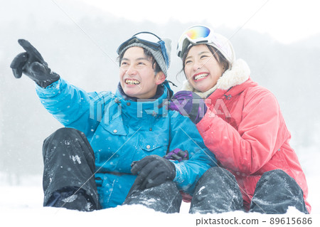 Couple enjoying the snowy mountains Couple enjoying the snowy mountains 89615686