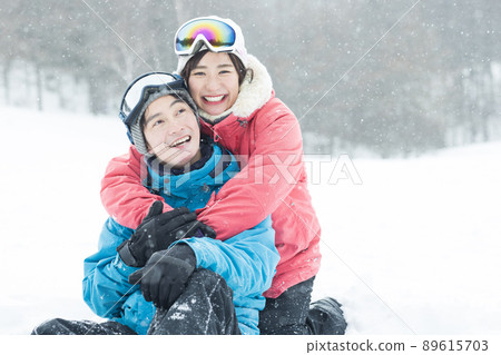 Couple enjoying the snowy mountains Couple enjoying the snowy mountains 89615703