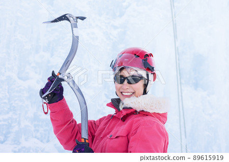 A woman enjoying ice climbing A woman enjoying ice climbing 89615919