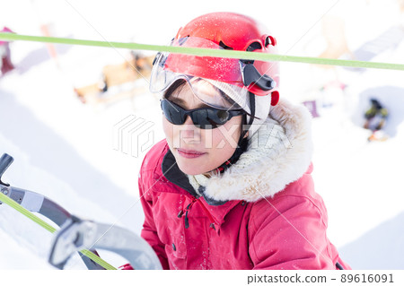 A woman enjoying ice climbing A woman enjoying ice climbing 89616091