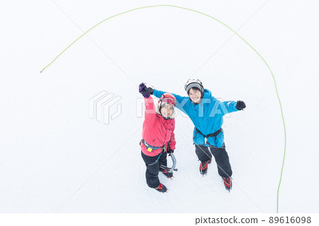 Men and women enjoying ice climbing Men and women enjoying ice climbing 89616098