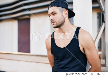 Handsome tired young man relaxing after workout Handsome tired young man relaxing after workout 89616133