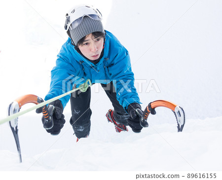 Men enjoying ice climbing 89616155