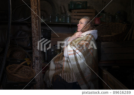 Frightened woman hide from explosions in the basement. During the sirens due to the shelling of Kyiv. Ukraine. 26 February 2022 Frightened woman hide from explosions in the basement. During the sirens due to the shelling of Kyiv. Ukraine. 26 February 2022 89616289