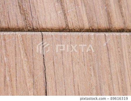damaged laminate close-up. cracked flooring. High quality photo damaged laminate close-up. cracked flooring. High quality photo 89616319