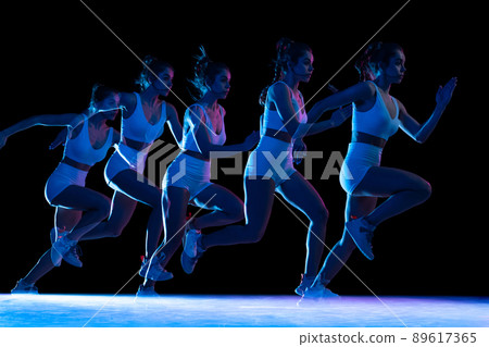 Development of movements. Professional female athlete, runner training isolated on dark background with stroboscope effect. Development of movements. Professional female athlete, runner training isolated on dark background with stroboscope effect. 89617365