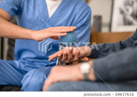 Experienced rehabilitation doctor conducting a physiotherapy session 89617618