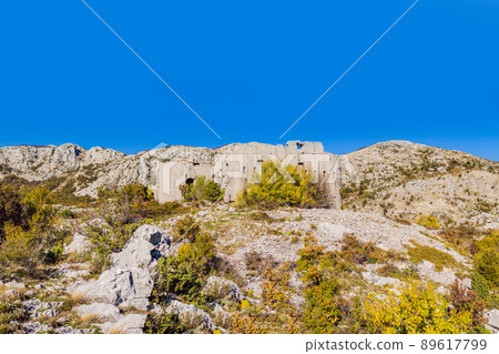Collapsing tower of fortress Kosmac. Ancient Austro-Hungarian fortress built as a defensive structure and an observation post. Montenego Collapsing tower of fortress Kosmac. Ancient Austro-Hungarian fortress built as a defensive structure and an observation post. Montenego 89617799