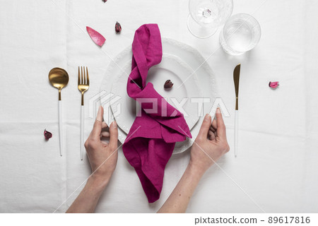 Fuchsia linen napkin on the white dish Fuchsia linen napkin on the white dish 89617816
