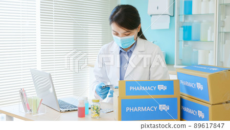 asian pharmacist pack medication 89617847