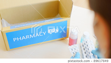 asian pharmacist pack medication 89617849