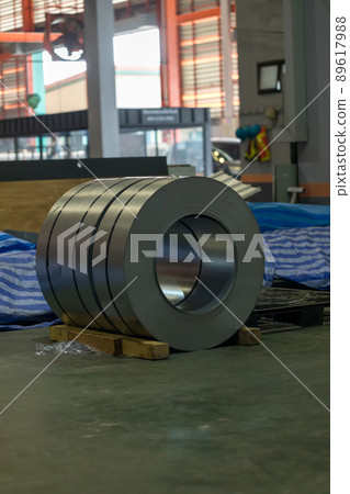 Roll of steel sheet in a plant. Rolls of sheet steel of Factory. Coils of steel stripes in store Roll of steel sheet in a plant. Rolls of sheet steel of Factory. Coils of steel stripes in store 89617988