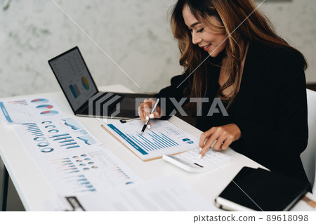 usiness analyzing investment charts with calculator laptop. Accounting and technology in office.Business people using laptop at office,Analyze plans.selective focus. usiness analyzing investment charts with calculator laptop. Accounting and technology in office.Business people using laptop at office,Analyze plans.selective focus. 89618098
