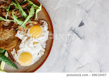 Breakfast made from fried eggs and potato puncakes Breakfast made from fried eggs and potato puncakes 89618407