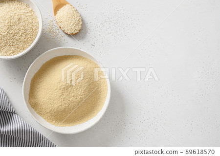 Sesame flour in wooden spoon on white. Sesame flour in wooden spoon on white. 89618570