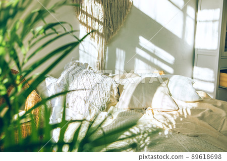 green fresh tropical houseplant palm leaves with blurred cozy bedroom background 89618698