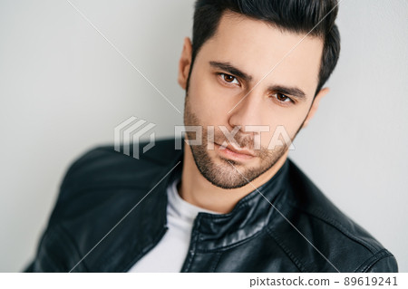 Closeup portrait of handsome thoughtful man posing on white studio background 89619241