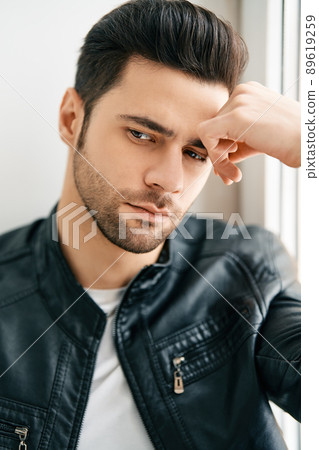 Closeup portrait of handsome thoughtful man posing on white studio background 89619259