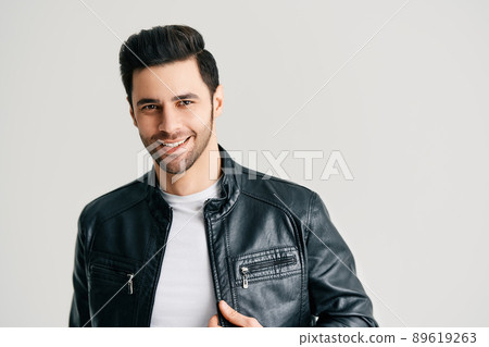 Closeup portrait of happy handsome trendy man posing on white studio background Closeup portrait of happy handsome trendy man posing on white studio background 89619263