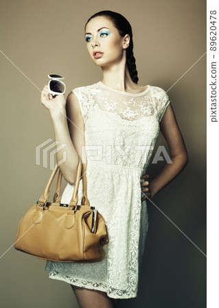 Portrait of beautiful young woman with a leather bag Portrait of beautiful young woman with a leather bag 89620478