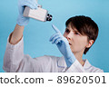portrait of a young Caucasian female doctor looking at CCTV camera as an idea of monitoring doctors at work 89620501