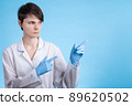 doctor a girl in a white coat and gloves points to the side. preparation for the writing of text 89620502