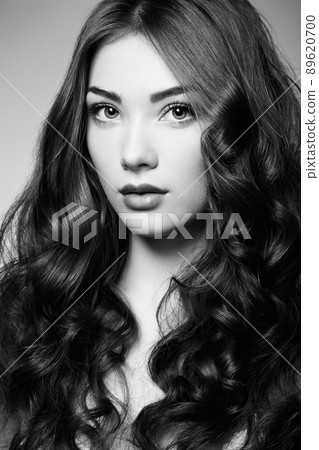 Portrait young beautiful woman with curly hair Portrait young beautiful woman with curly hair 89620700