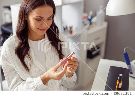 Happy attractive woman visiting nail beauty salon Happy attractive woman visiting nail beauty salon 89621391