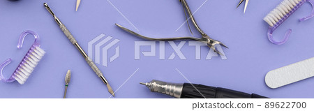 Set of cosmetic tools for manicure and pedicure on a purple background Set of cosmetic tools for manicure and pedicure on a purple background 89622700