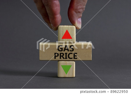 Gas price symbol. Businessman holds a wooden cube with arrow symbolizing that Gas price are going down or up. Beautiful grey table grey background. Business and gas price concept. Copy space. Gas price symbol. Businessman holds a wooden cube with arrow symbolizing that Gas price are going down or up. Beautiful grey table grey background. Business and gas price concept. Copy space. 89622950
