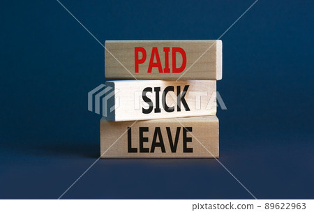 Paid sick leave symbol. Concept words Paid sick leave on wooden blocks. Beautiful grey table grey background. Business medical and paid sick leave concept. Copy space. 89622963