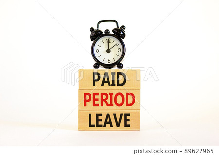 Paid period leave symbol. Concept words Paid period leave on wooden blocks. Black alarm clock. Beautiful white table white background. Business medical paid period leave concept. Copy space. 89622965