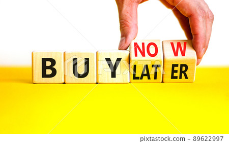 Buy later or now symbol. Businessman turns wooden cubes and changes concept words Buy later to Buy now. Beautiful yellow table white background. Business buy later or now concept. Copy space. Buy later or now symbol. Businessman turns wooden cubes and changes concept words Buy later to Buy now. Beautiful yellow table white background. Business buy later or now concept. Copy space. 89622997