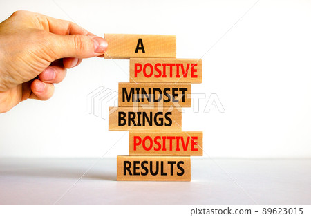 Positive mindset symbol. Wood blocks with words A positive mindset brings positive results. Beautiful white background Businessman hand. Business motivational positive mindset concept. Copy space. Positive mindset symbol. Wood blocks with words A positive mindset brings positive results. Beautiful white background Businessman hand. Business motivational positive mindset concept. Copy space. 89623015