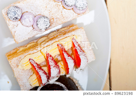 selection of fresh cream cake dessert plate 89623198