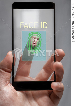 the concept of identification . the system reads the fingerprints of the phone owner. the human face is depicted on the tip of finger. 89623310